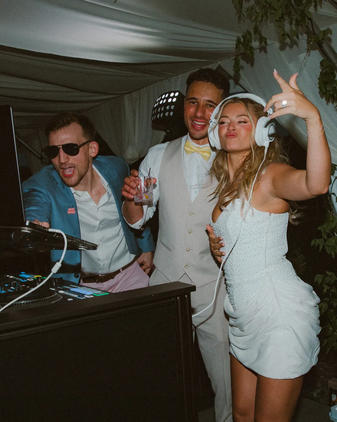 The couple partying at the DJ booth at a VARA wedding