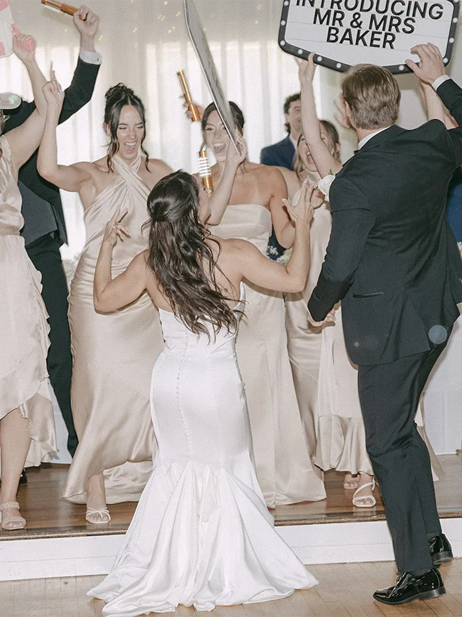 The couple's grand entrance, with the wedding party cheering them in