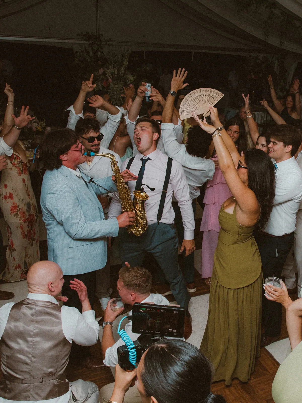 A packed dance floor with a live sax player at a VARA wedding